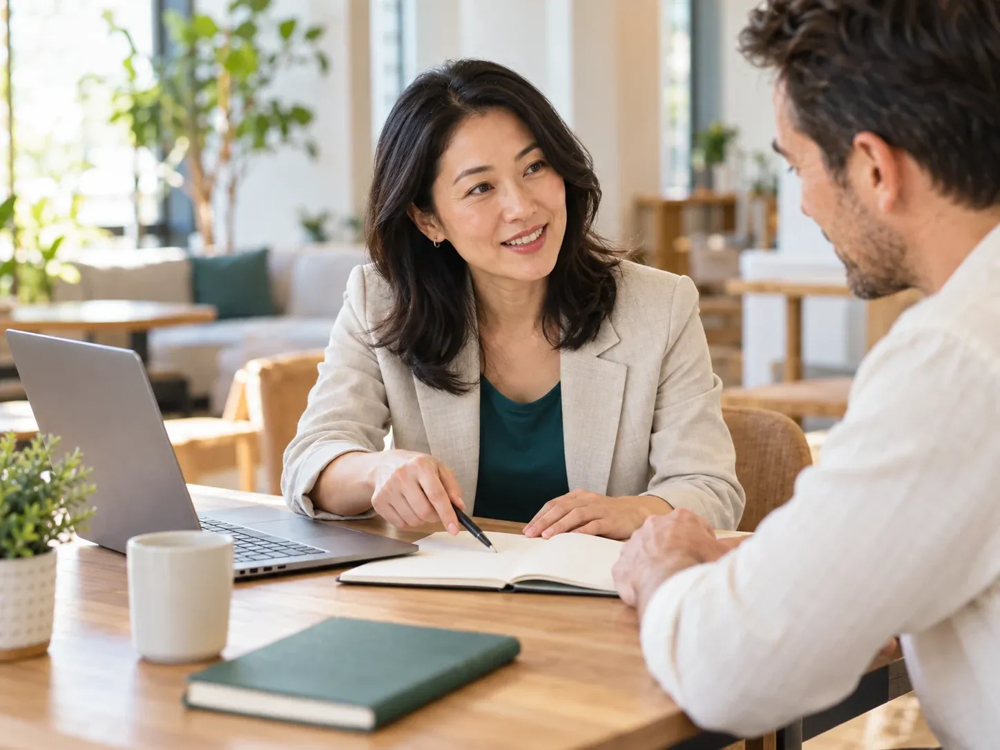 A consultant reviewing notes with a client across a table