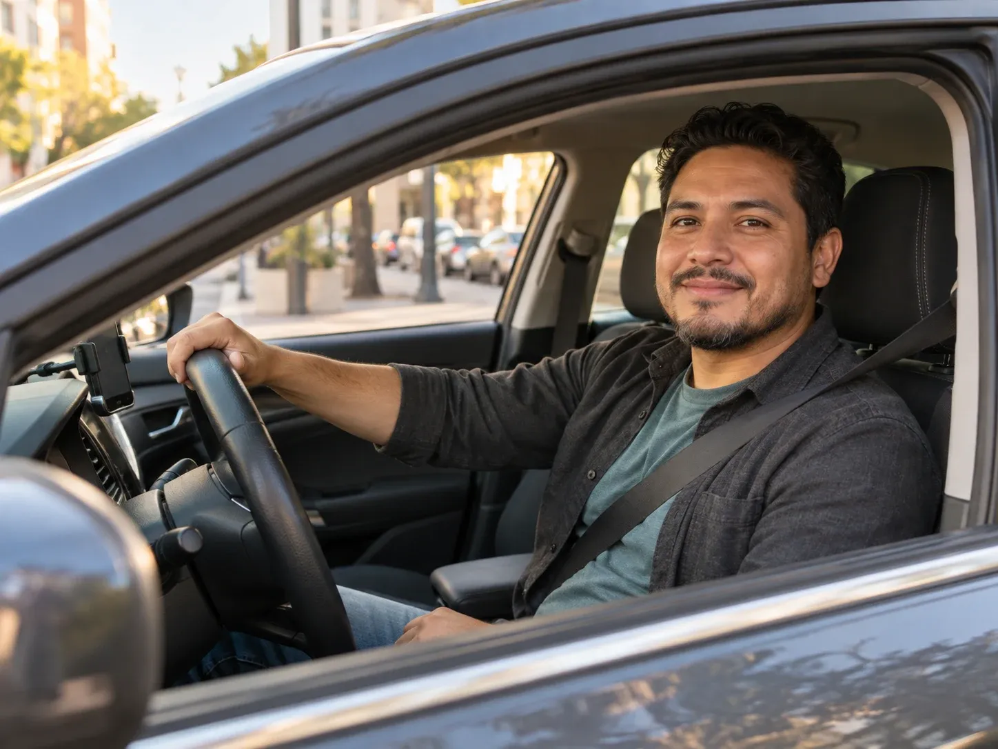 A smiling rideshare driver at the wheel, seen through the open driver's window